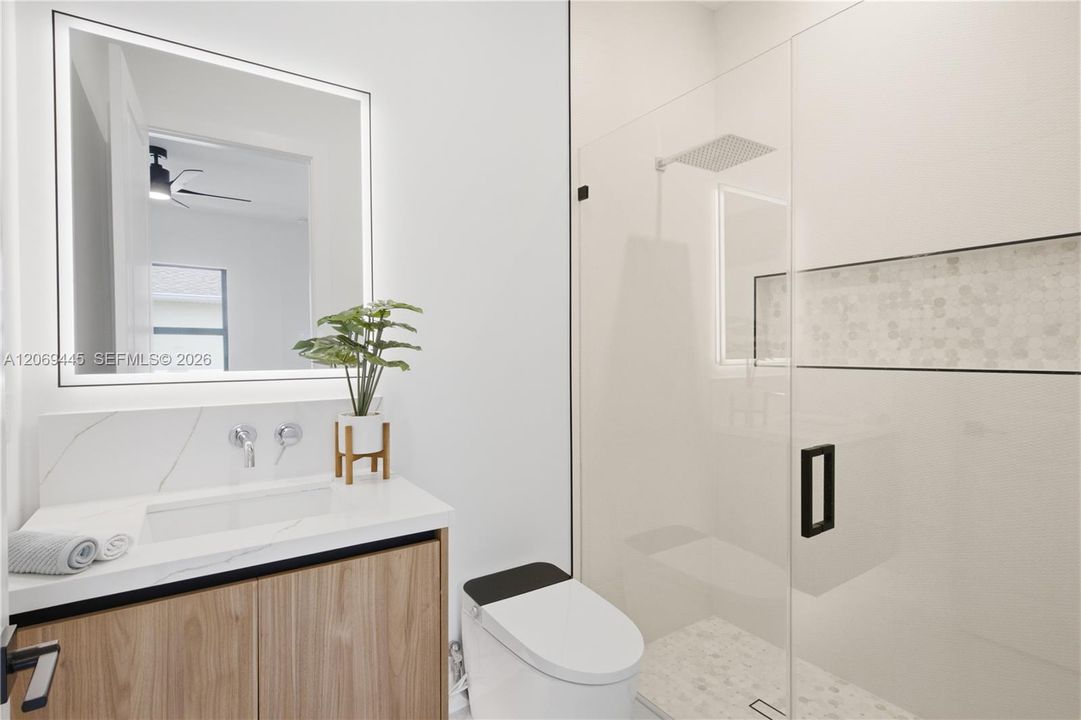 Private ensuite bathroom adds comfort and convenience to the second primary suite.