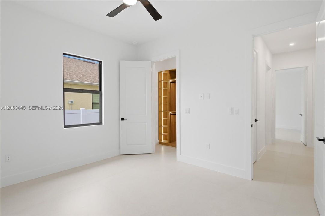 Spacious third bedroom offers comfort and abundant natural light.