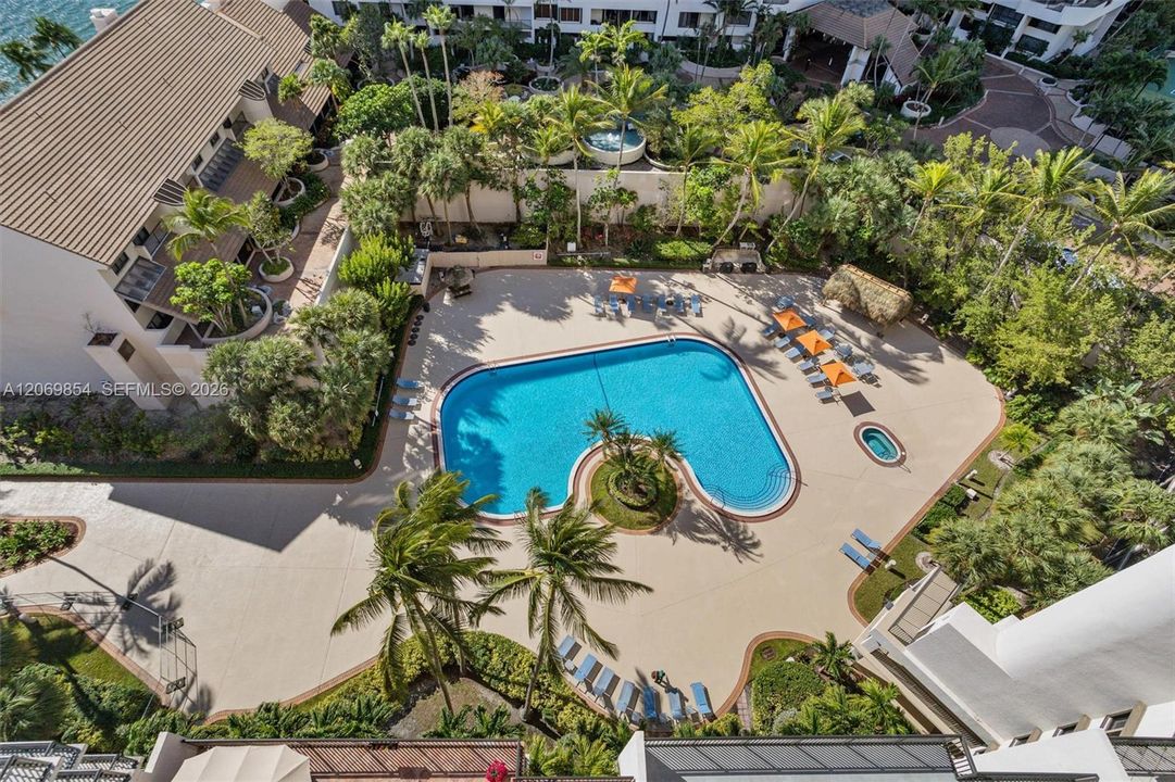 Immerse yourself in luxury with this stunning resort-style pool area, surrounded by lush tropical landscaping and swaying palm trees. Designed for relaxation and entertainment, this exclusive amenity includes a grand barbecue area perfect for outdoor gatherings