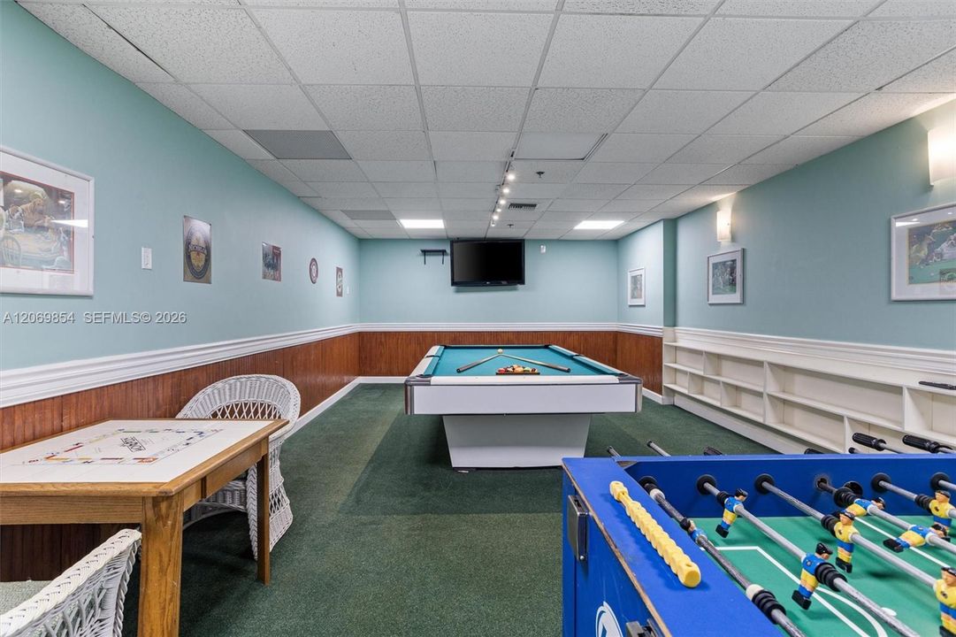 The warm ambiance and comfortable layout make this an ideal spot for hosting game nights or simply enjoying a leisurely afternoon. Whether you're a billiards enthusiast or just looking for a space to socialize, this dedicated game room enhances the lifestyle of this exceptional residence
