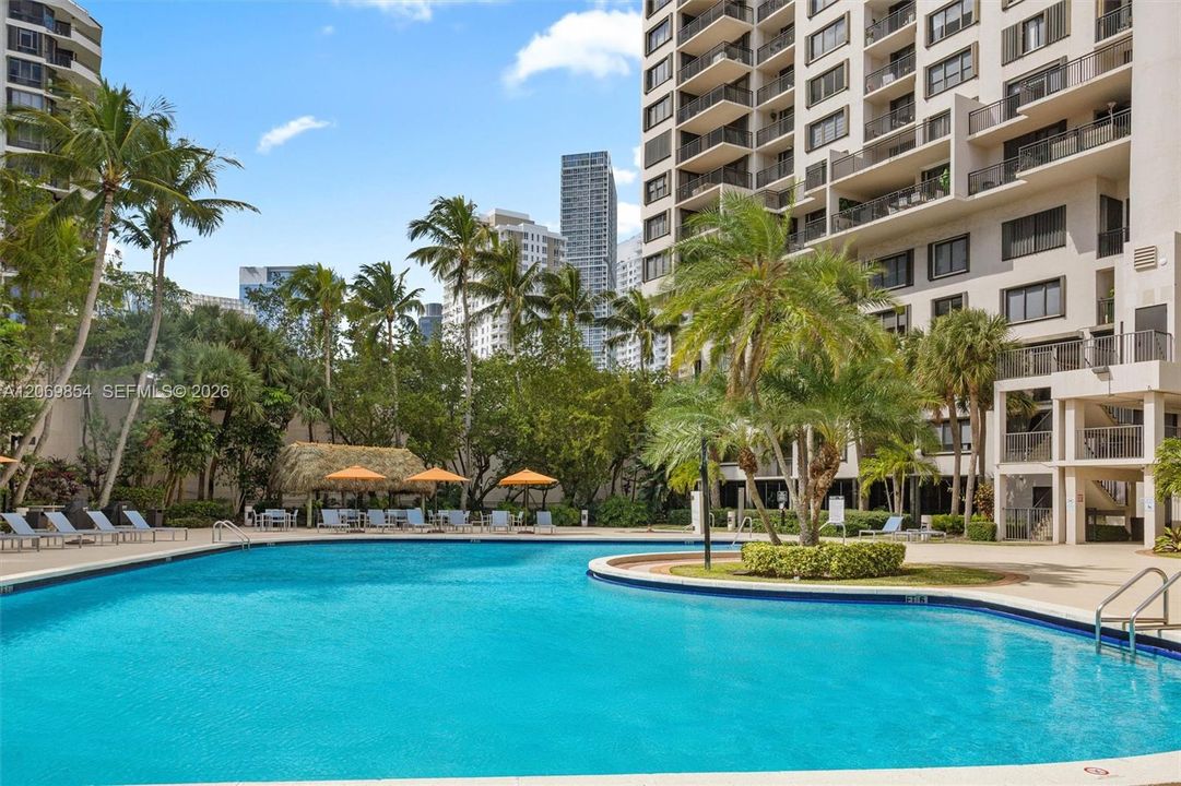 Welcome to a tropical paradise where luxury meets relaxation! This stunning resort-style pool is surrounded by lush landscaping, creating a private retreat. Whether you’re taking a refreshing dip, lounging under the swaying palms, or soaking up the sun, this poolside escape offers the ultimate in comfort and tranquility.