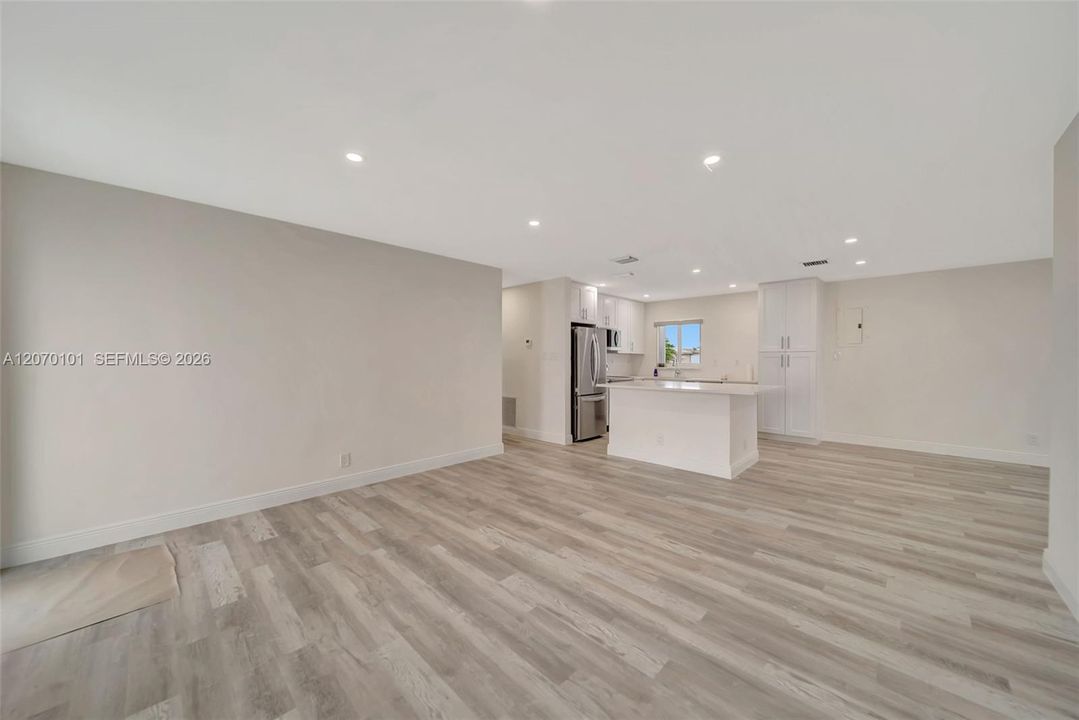 Wide, island + fridge, barn door in background