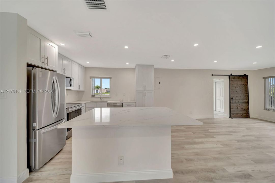 From living room, island + fridge/stove