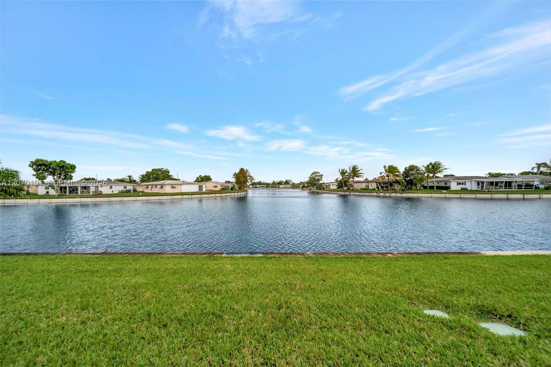 Lake view with palm, neighboring homes