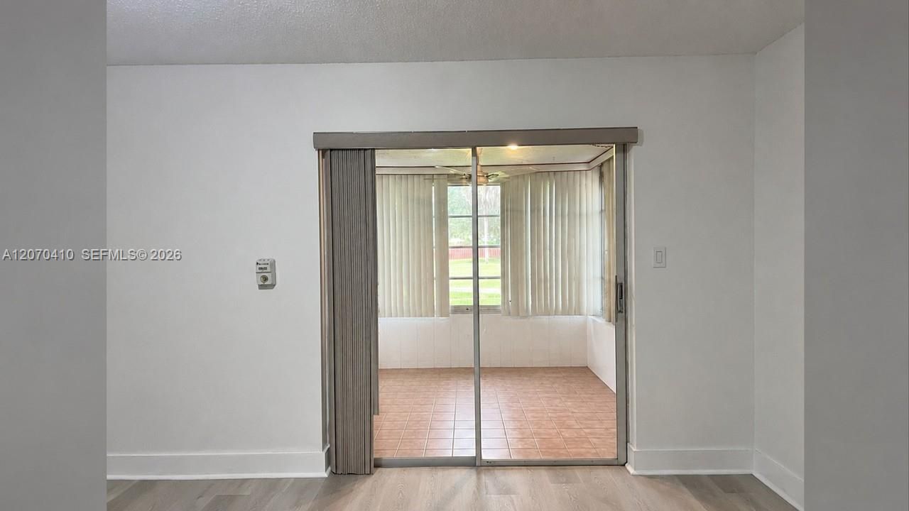 Sliding Glass Door to Enclosed Porch Digitally Decluttered