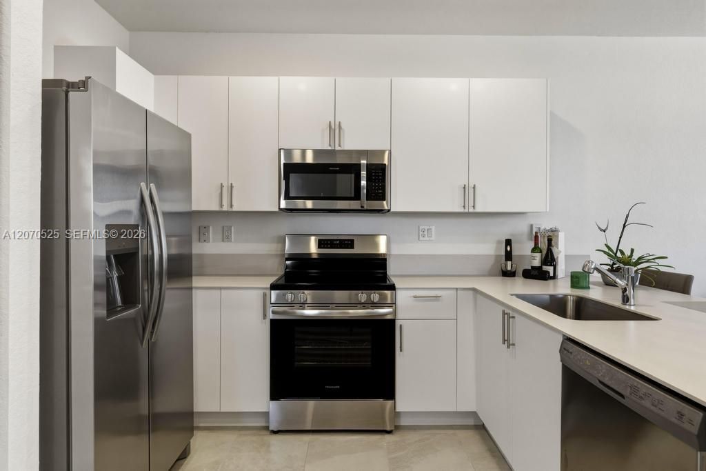 Stainless-steel appliances, a full-size refrigerator, range, microwave and dishwasher, plus plenty of storage.