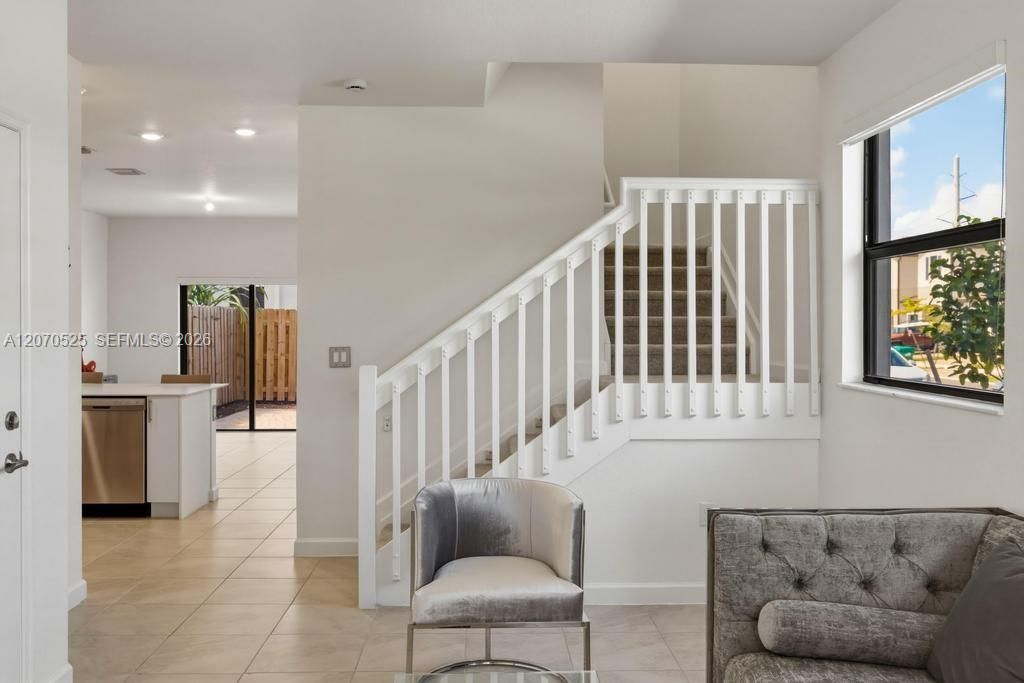 The staircase creates a natural transition between the home's social and private spaces.