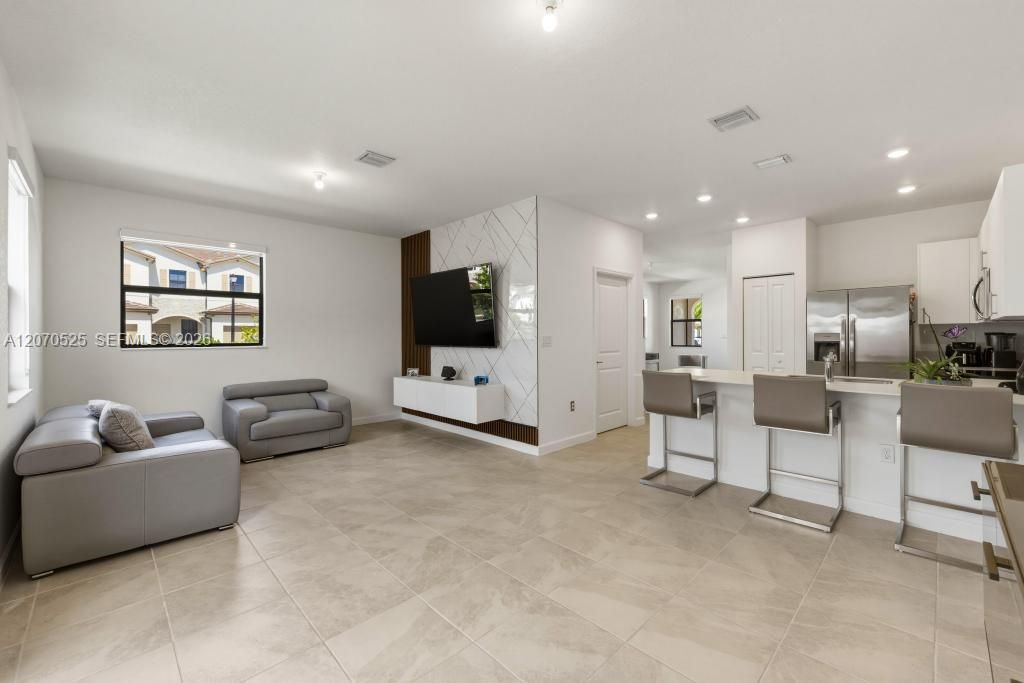 The marble-look finish paired with warm vertical wood detailing gives the room a little personality without overwhelming the clean design of the home.