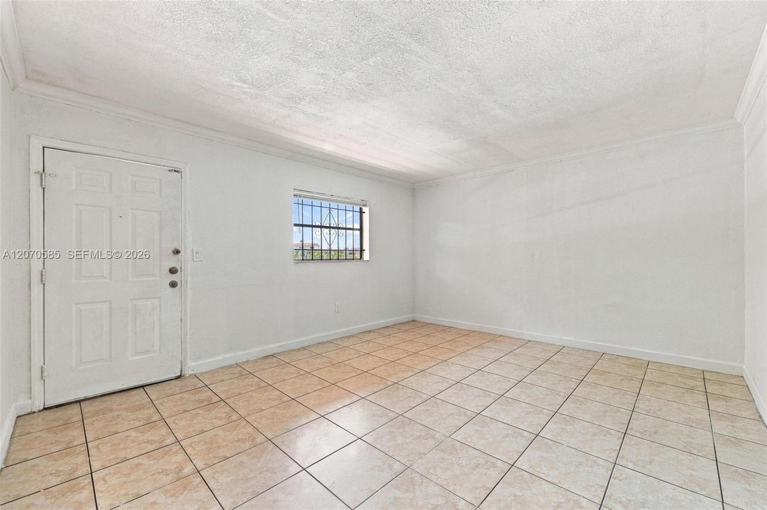 A bright, open living area with neutral walls and tile flooring gives you a clean canvas from day one.