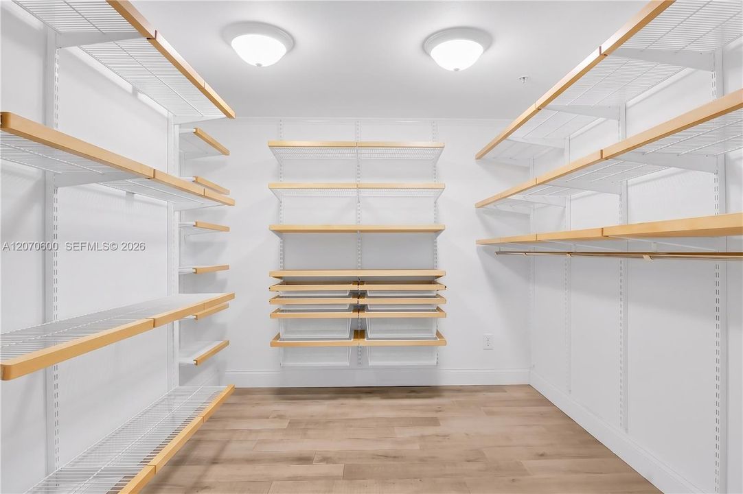 Primary bedroom walk in closet