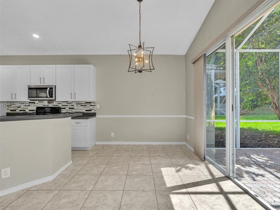 Bright eat in kitchen providing a comfortable space for casual dining and morning coffee.
