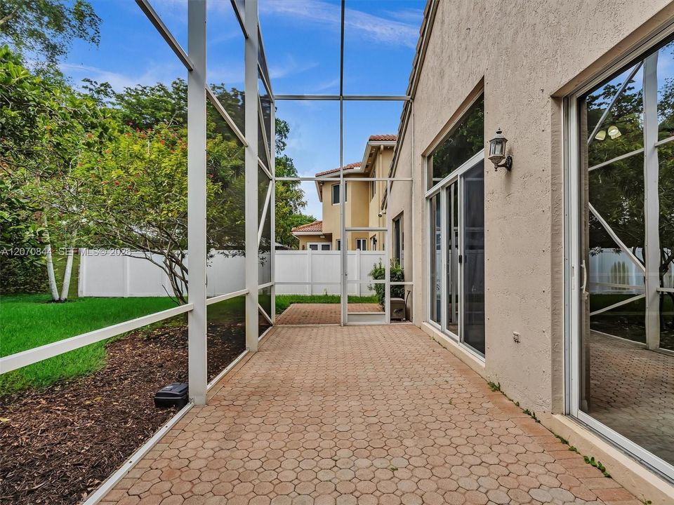 Expansive screened-in patio creating an ideal outdoor living space for relaxing or entertaining all year round.