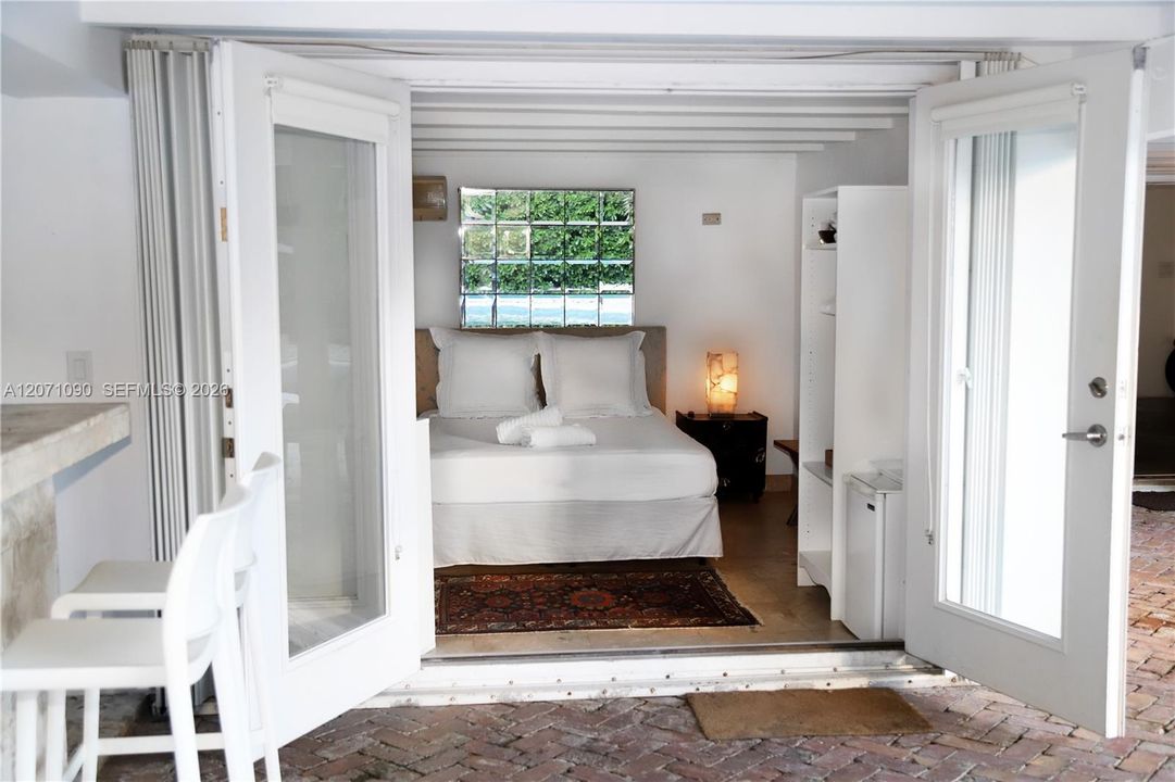 outside bedroom with bath by pool