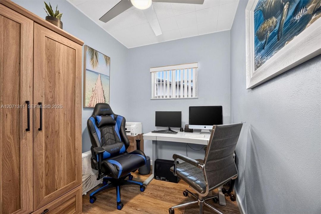 Office space opposite full-over-full bunk beds w/wardrobe for guests