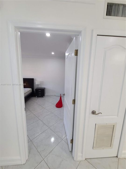 Entry to Living room. Right door is the A/C closet, followed by another closet