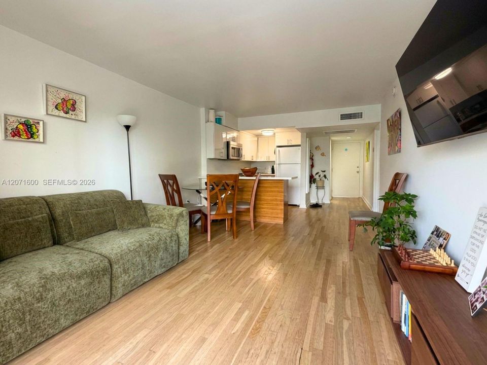 Bright and open-concept living area featuring beautiful wood floors and seamless flow.