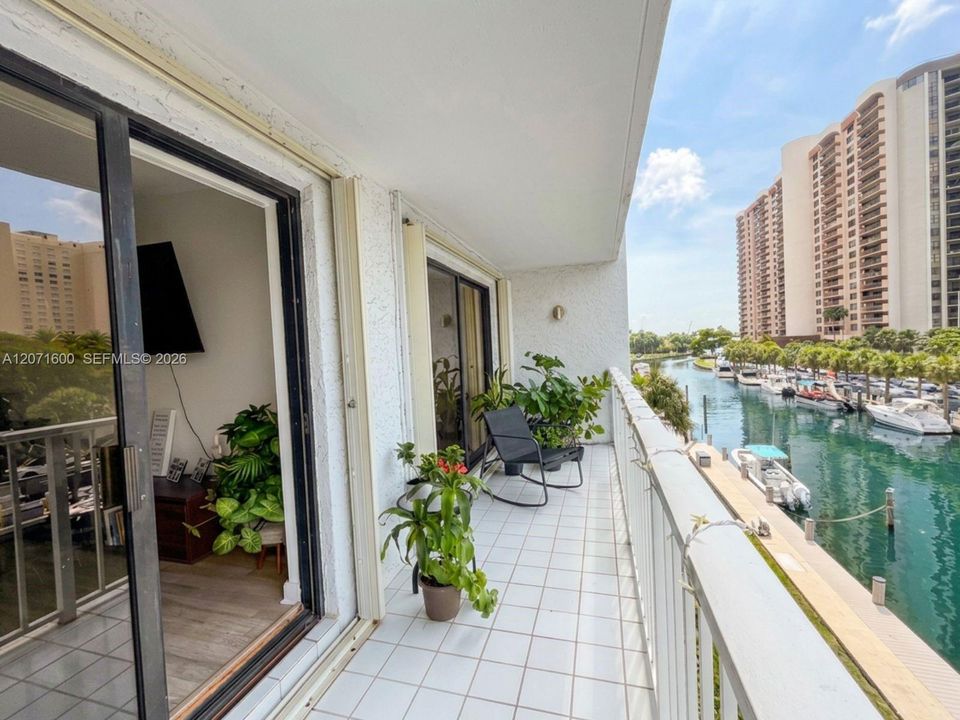 Expansive private balcony with peaceful canal views, ideal for outdoor dining and relaxing.