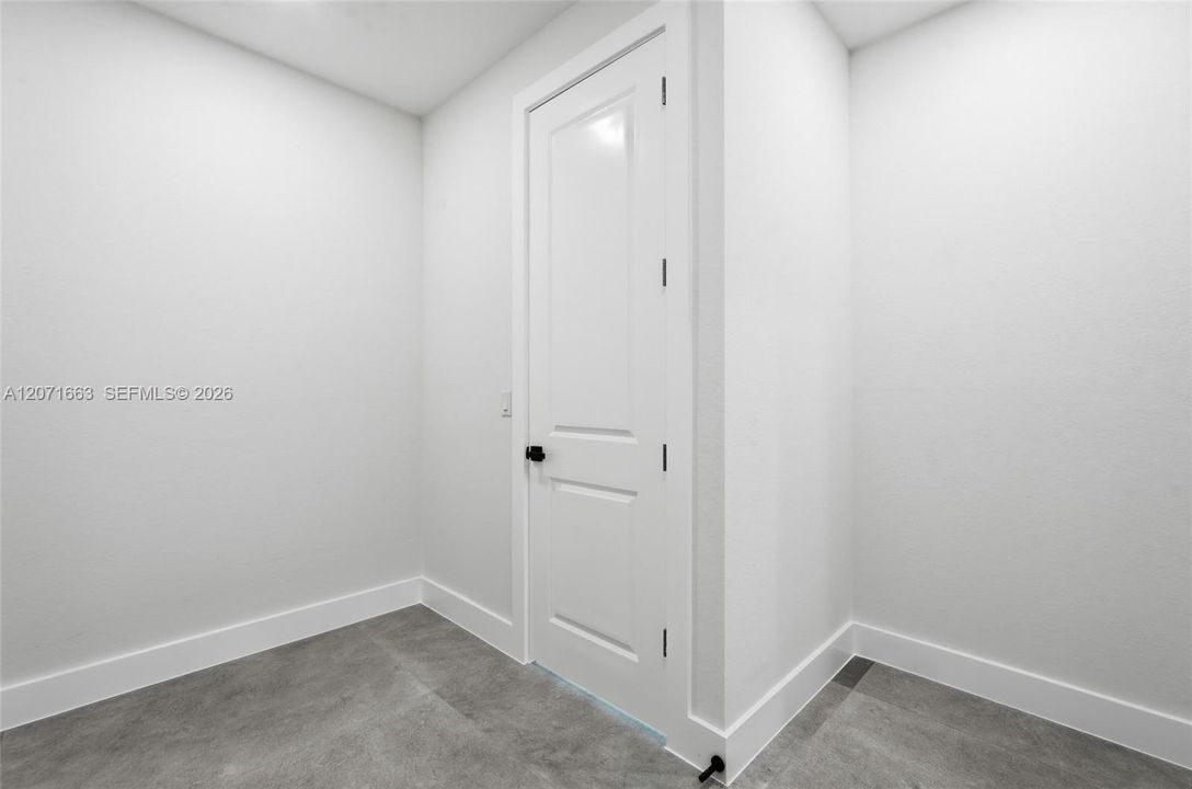 Walk in closet with access to laundry