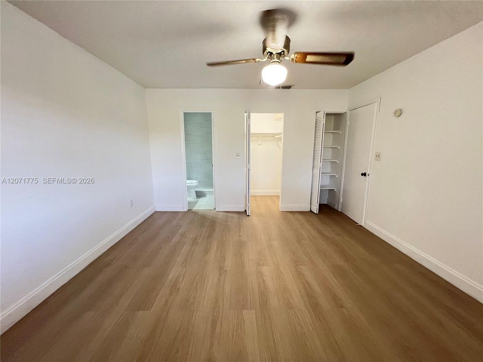 Primary bedroom with walk-in closet
