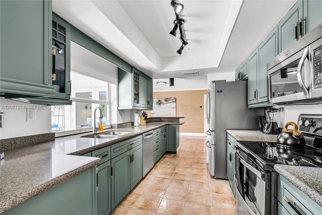 Chef's kitchen featuring stainless steel appliances and ample cabinetry