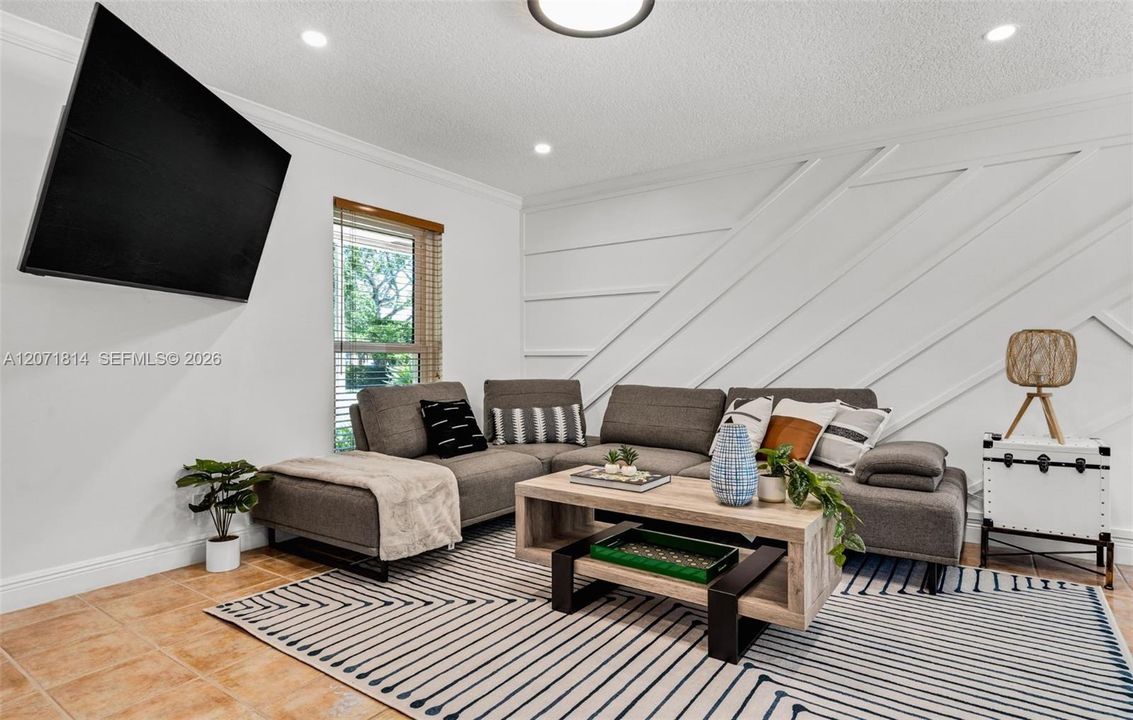 Cozy living room with wall-mounted TV, perfect for relaxing evenings