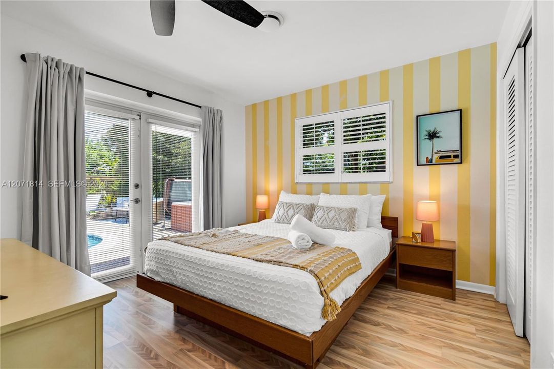 Bright bedroom with sliding glass doors leading to the outdoor patio