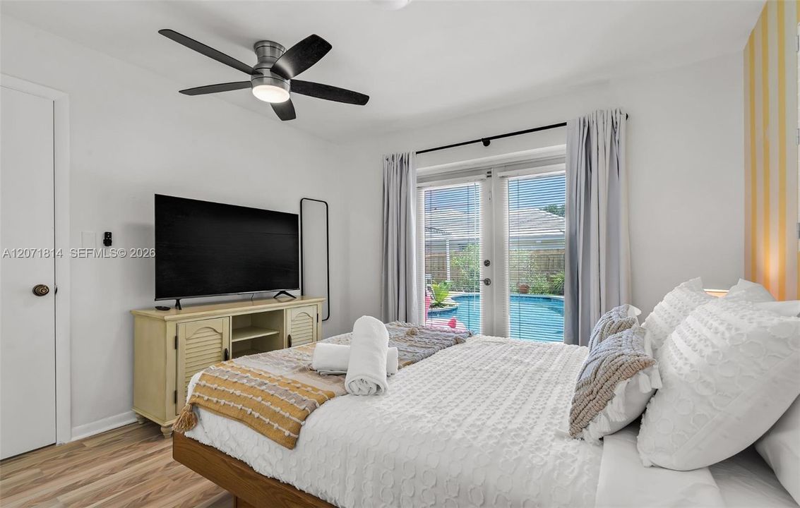 Serene primary bedroom with natural light and tranquil views