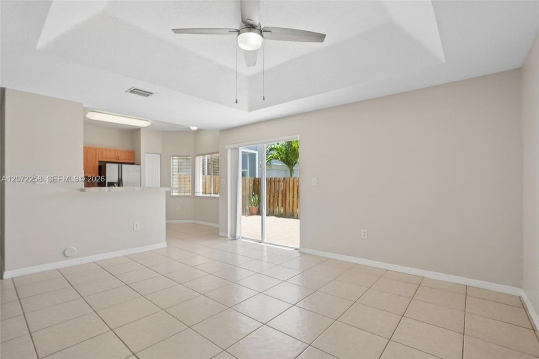 FAMILY ROOM FACING KITCHEN AND GLASS SLIDING DOORS FOR BRIGHTNESS
