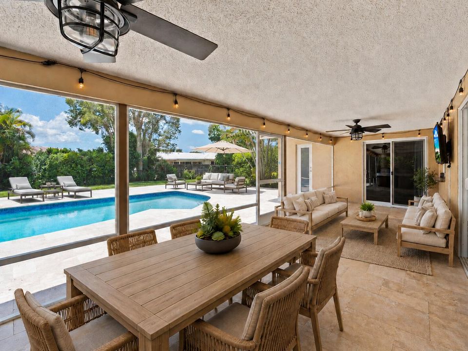 patio with furntiure and pool lounges an