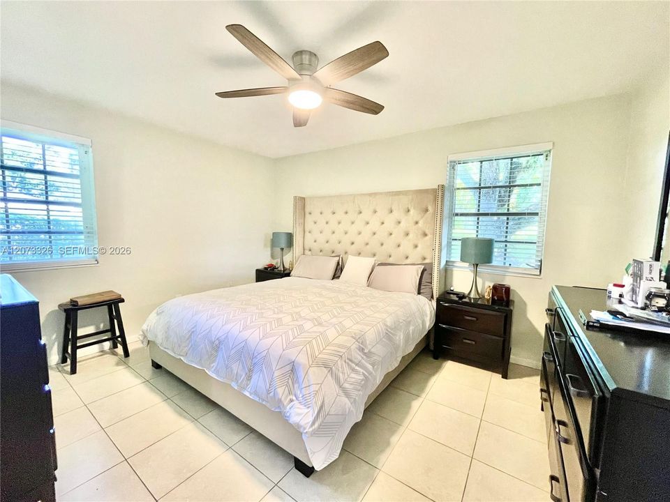 Primary bedroom featuring King size bed and large chest of drawers.