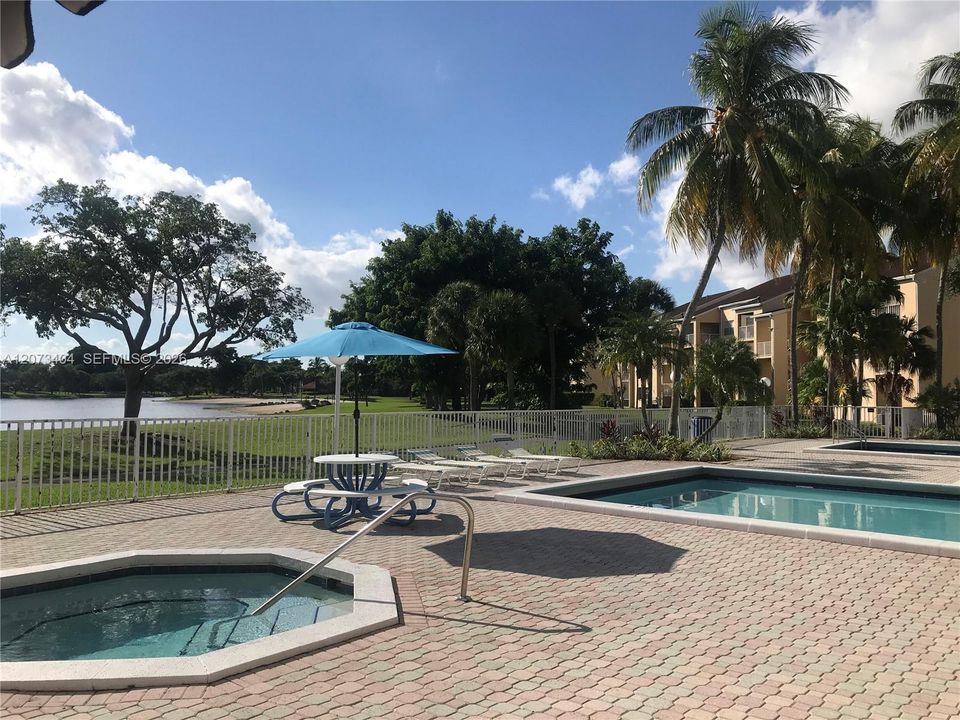 POOL NEXT TO LAKE AND WALKING-BIKE TRAIL IN HAMMOCKS TRAILS, ANOTHER IN THE CLUB HOUSE