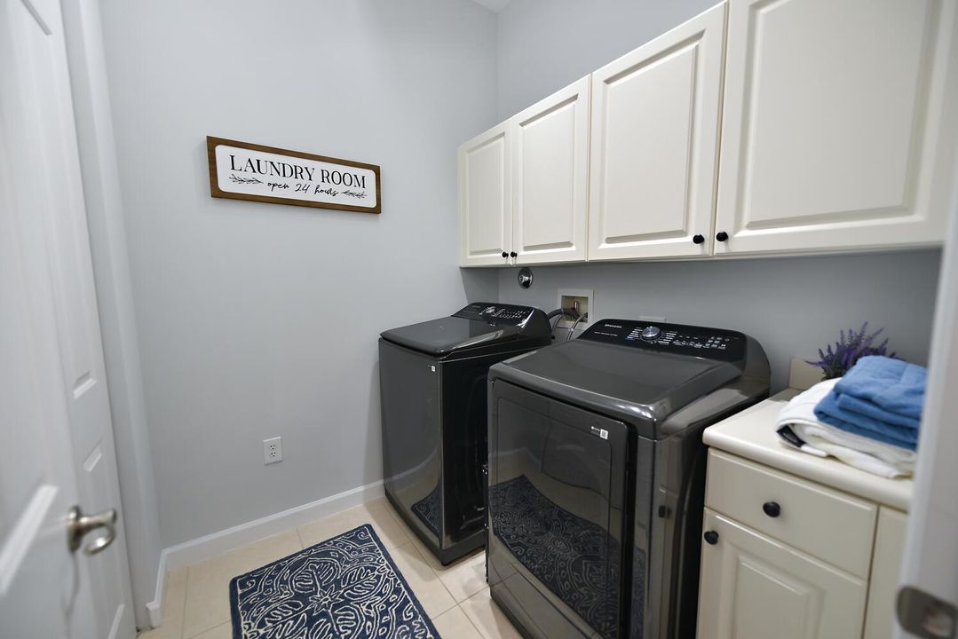 Laundry room with a large linen closet