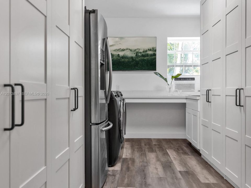 Oversized Laundry Room with Extra Refrigerator and Ample Storage