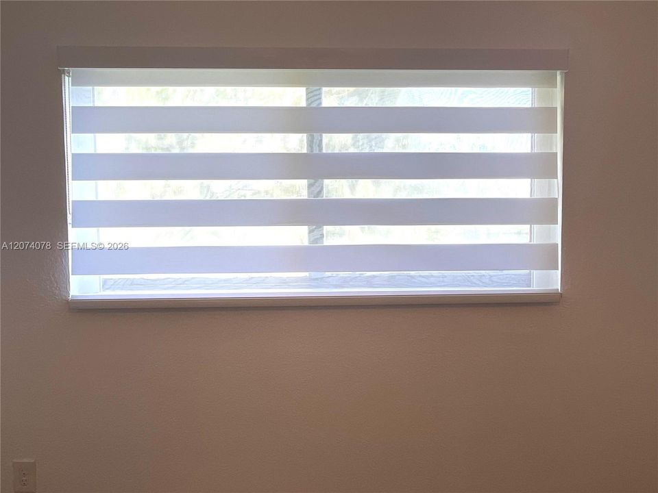 Zebra blinds in bedroom.