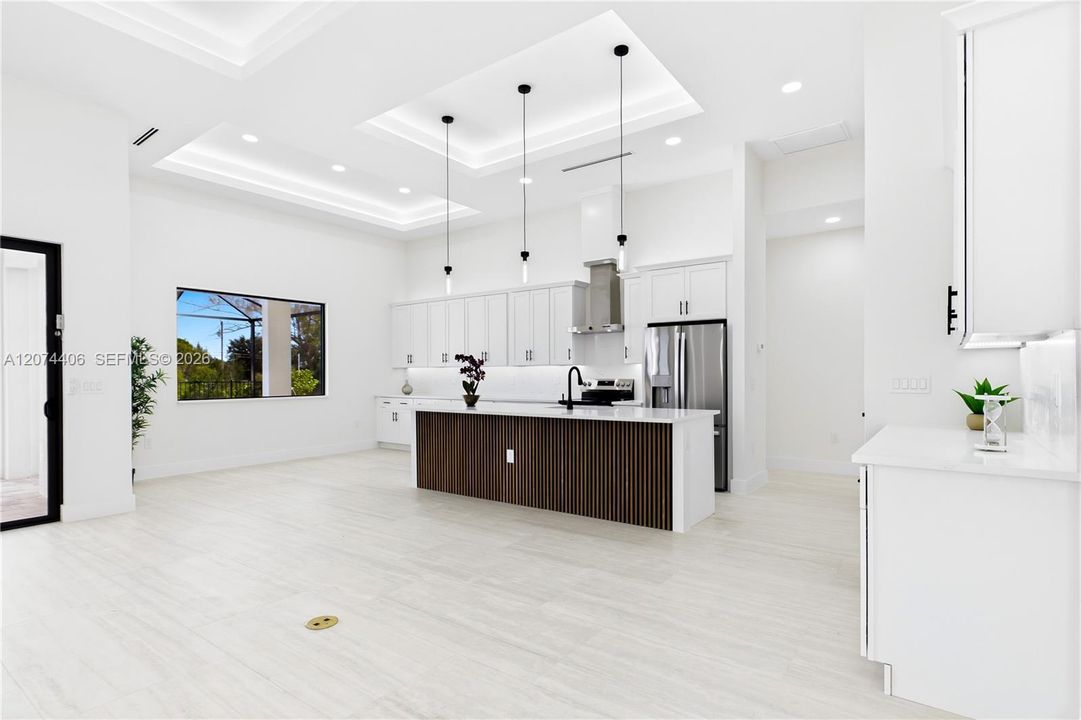QUARTZ COUNTERTOPS & FULL-HEIGHT QUARTZ BACKSPLASH w/ clean modern palette, while UNDER-CABINET LED LIGHTING enhances bright, open ambiance.