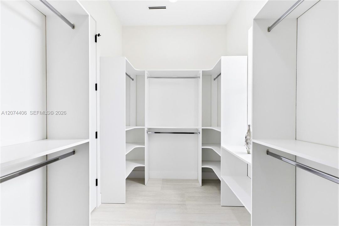 START & END YOUR DAY ORGANIZED w/ an expansive CUSTOM WALK-IN CLOSET offering abundant built-in shelving & hanging space for effortless everyday living!