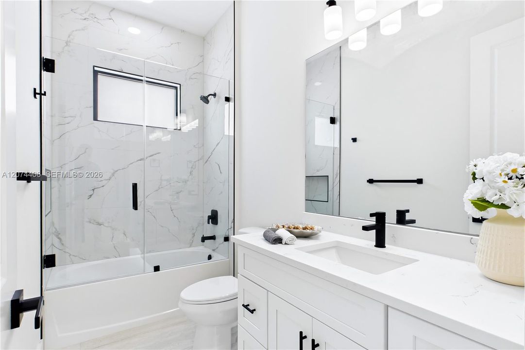 STYLISH HALL BATHROOM makes everyday routines effortless w/ a bright modern design, QUARTZ vanity & beautifully tiled TUB/SHOWER. Perfectly positioned for FAMILY & GUESTS while maintaining the home’s cohesive CONTEMPORARY STYLE!