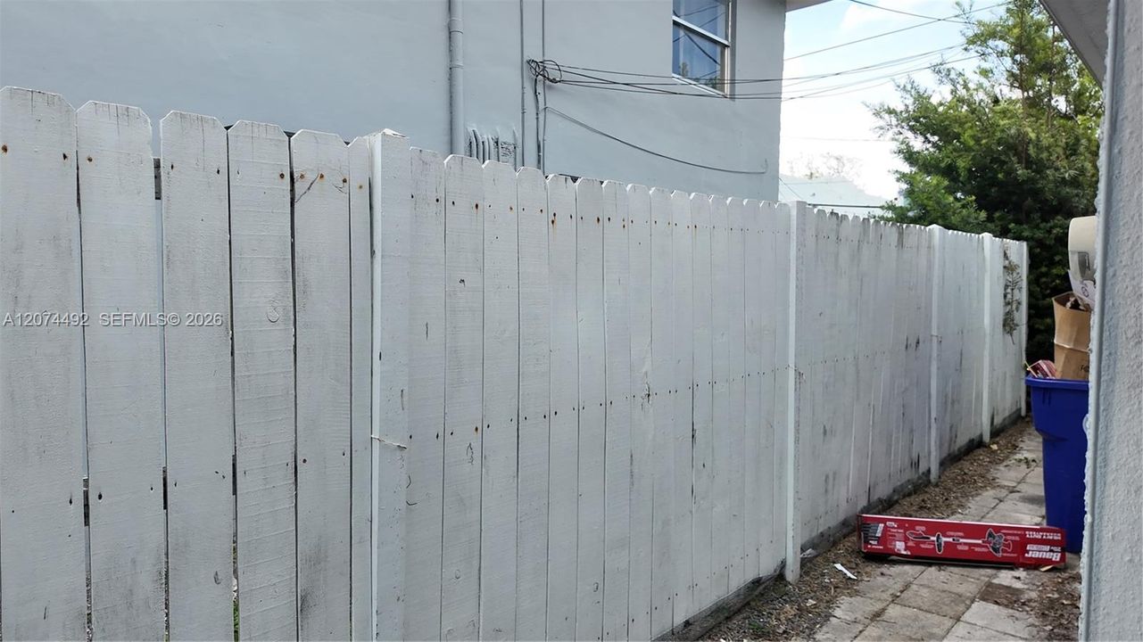 the side passage and fencing emphasize separation and privacy.