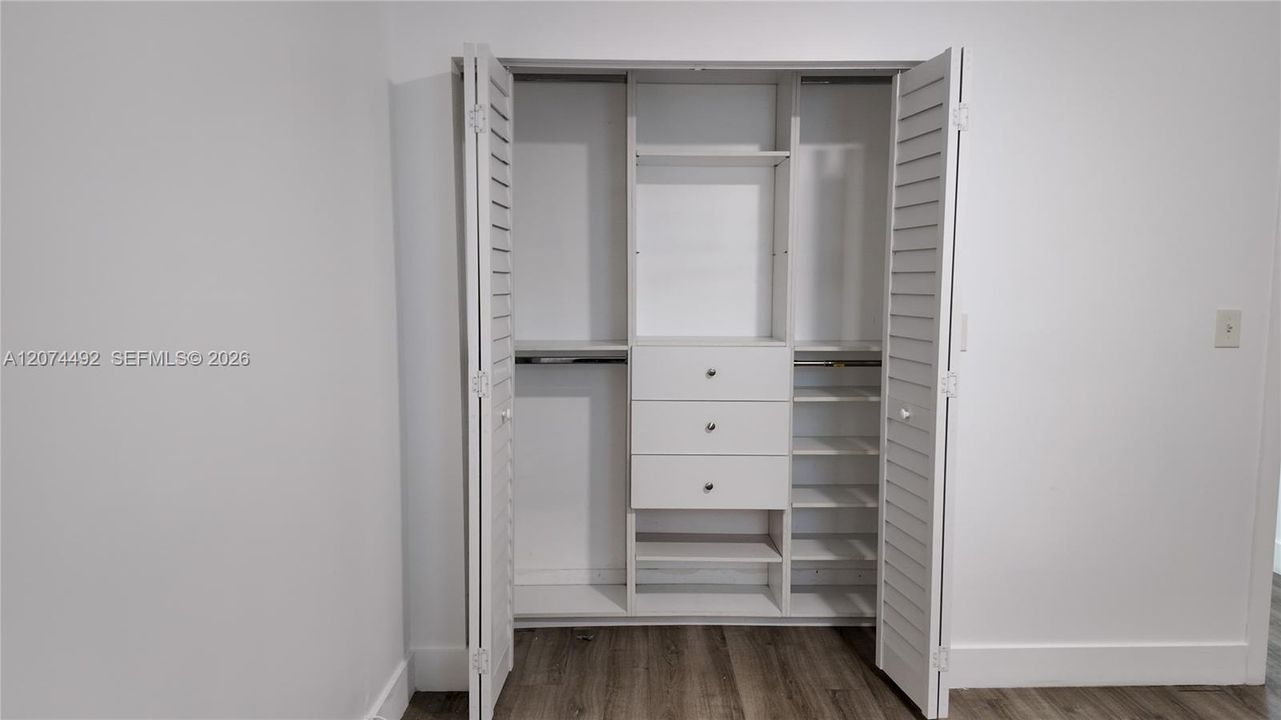 Instead of one basic hanging rod, you have an organized closet system with multiple hanging sections, shelving, shoe storage and built-in drawers.