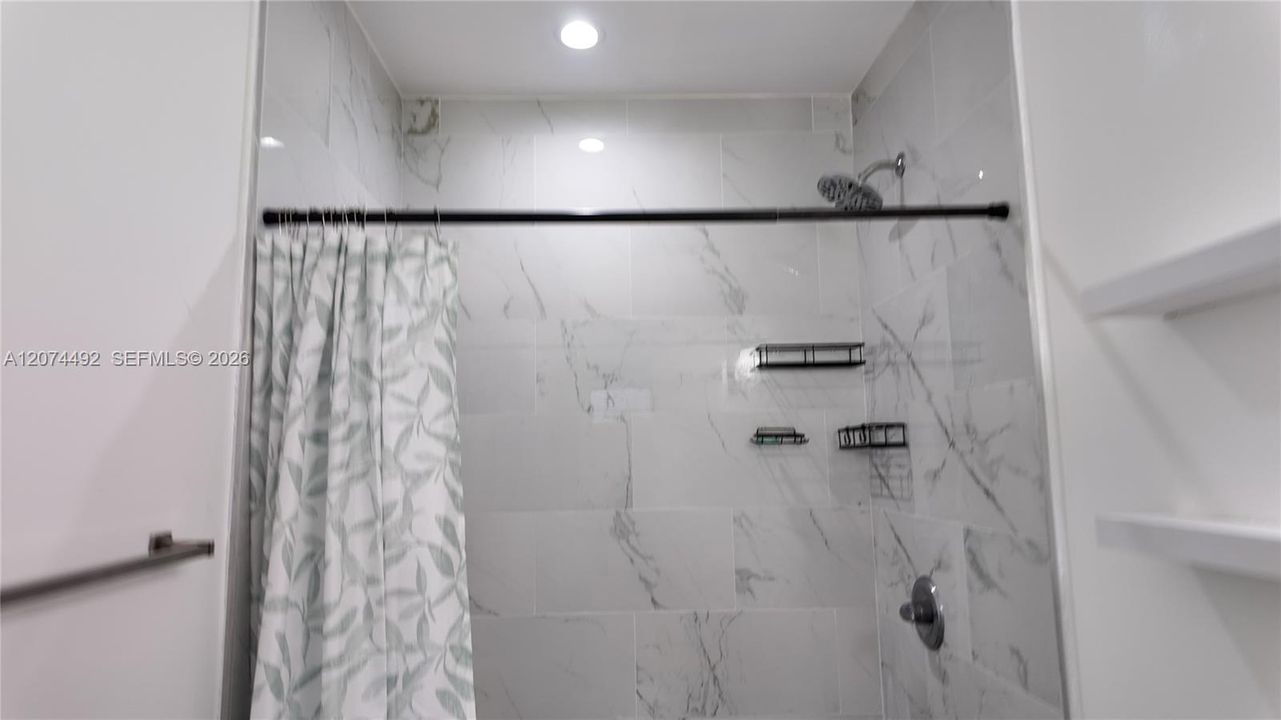 additional shower storage make the space practical without losing its polished look.