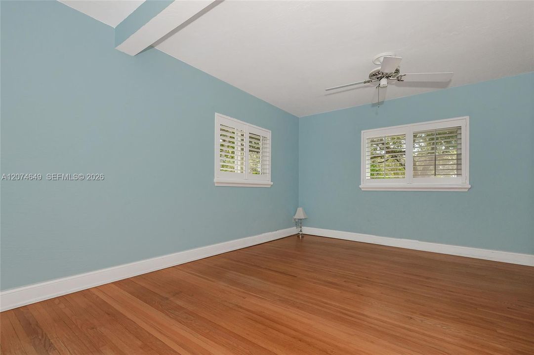 The view from the Primary bedroom entry door to the windows at the front and side of the home.