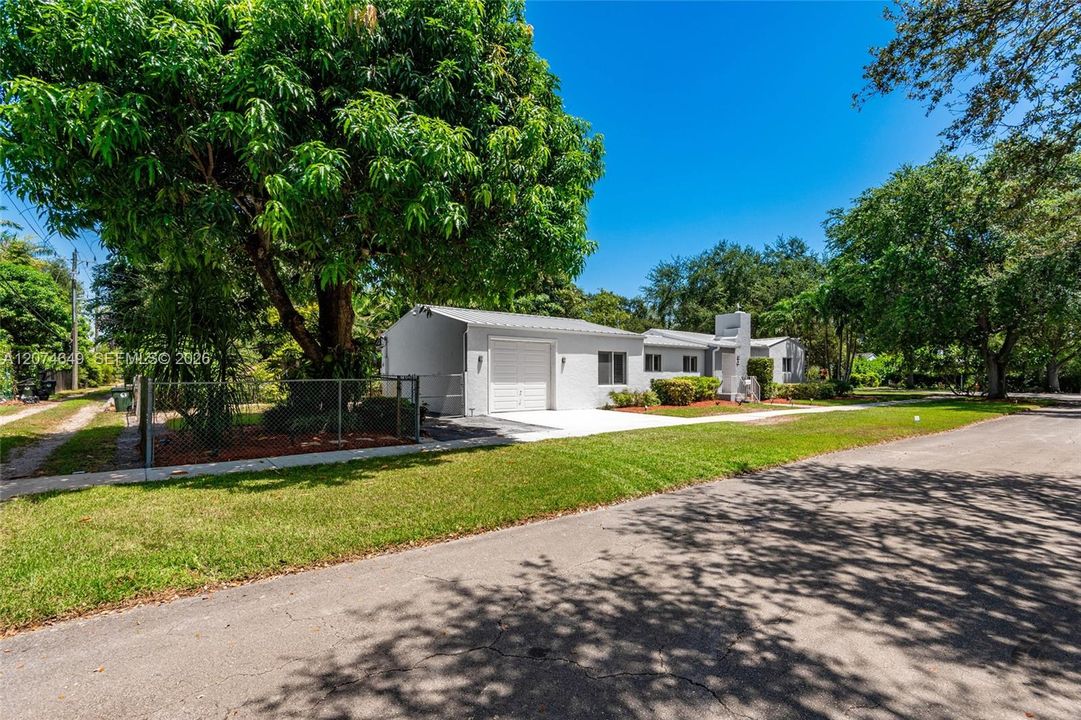 The fenced yard next to the garage has a large Mango tree that the seller says are delicious.  It also gives shade if you want to BBQ outdoors in your yard.