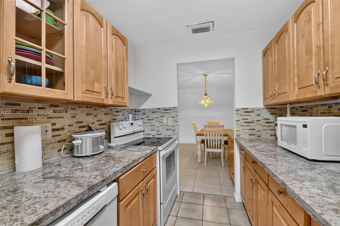 Updated kitchen with granite countertops and plenty of storage