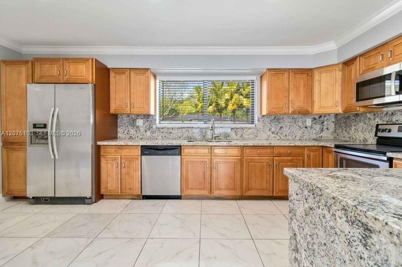Enjoy a huge marble counter top that was custom made for a conversation starter
