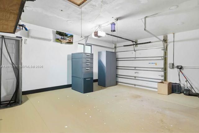 1 car garage with a split unit and a TV, perfect for a workshop.