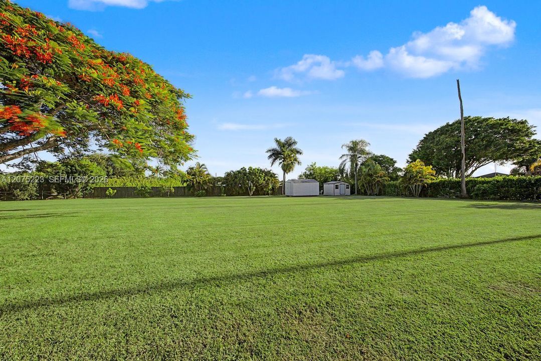 Expansive lawn showcases the property's spacious setting, with plenty of possibilities for outdoor living, recreation and entertaining.