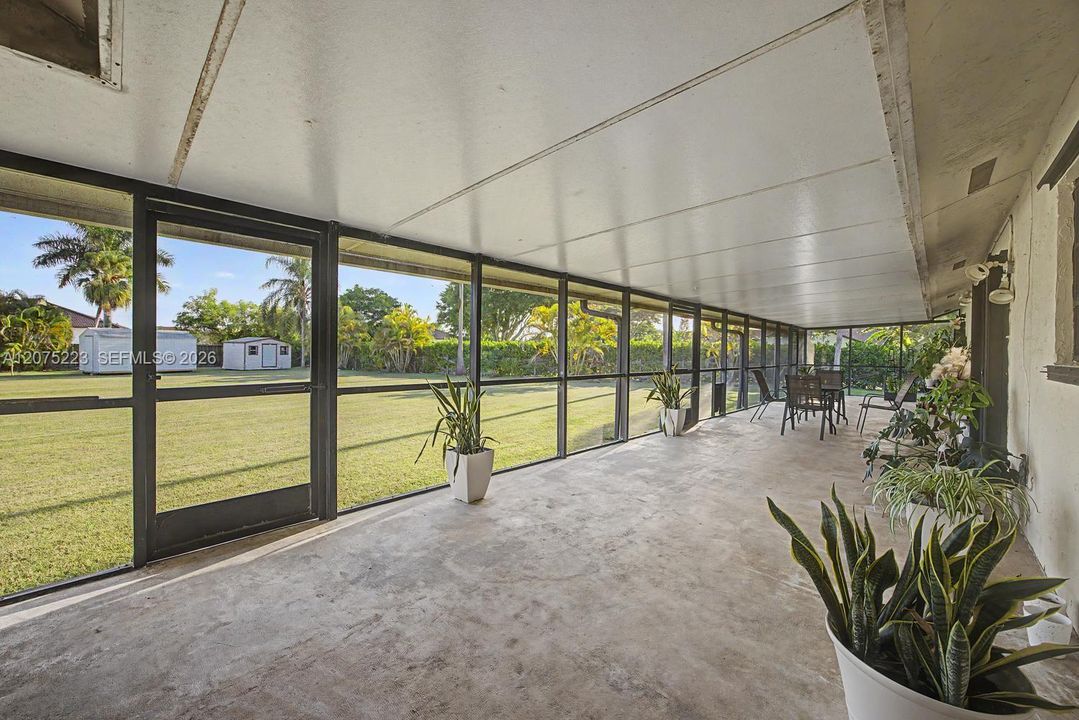 Expansive covered and screened porch provides plenty of room for outdoor dining, entertaining and relaxing.
