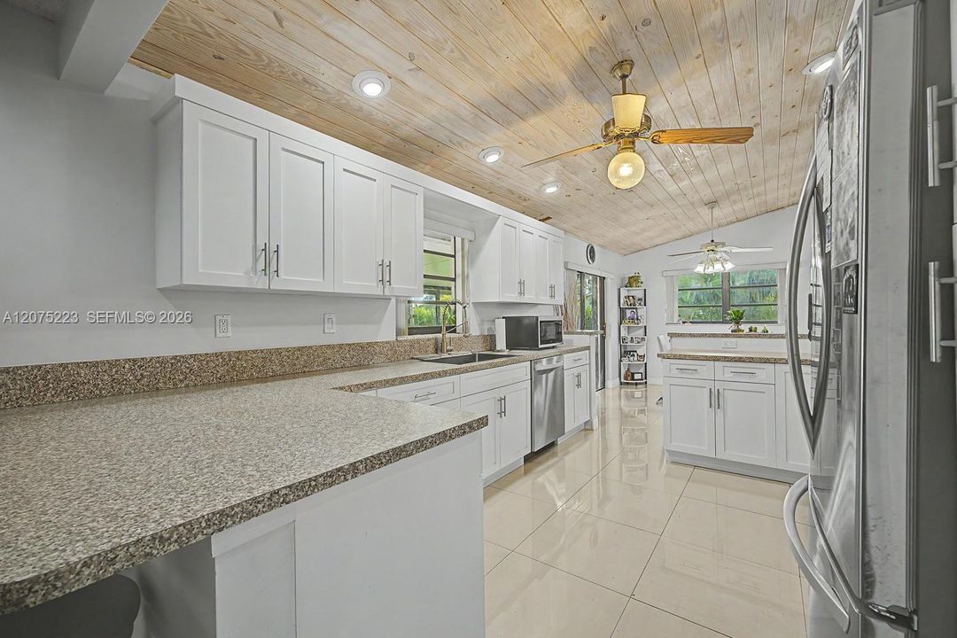 Functional kitchen layout offers generous prep space, storage and views into the adjoining living areas.