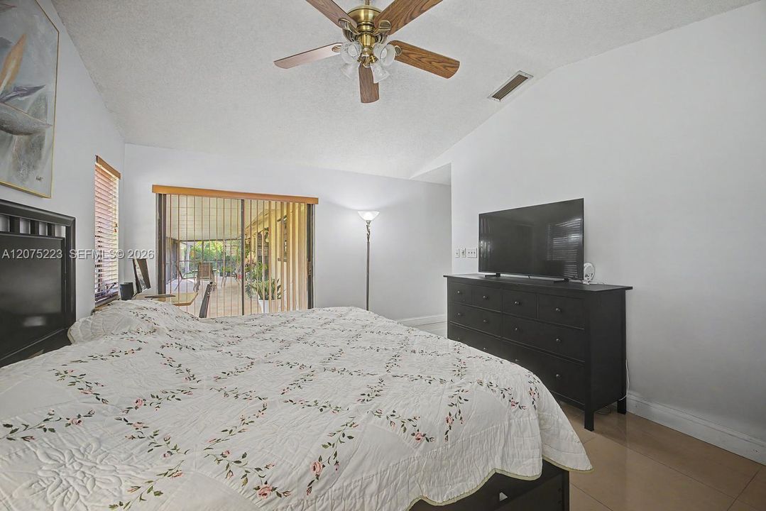 Primary suite offers direct access to the screened porch, extending the living space outdoors.