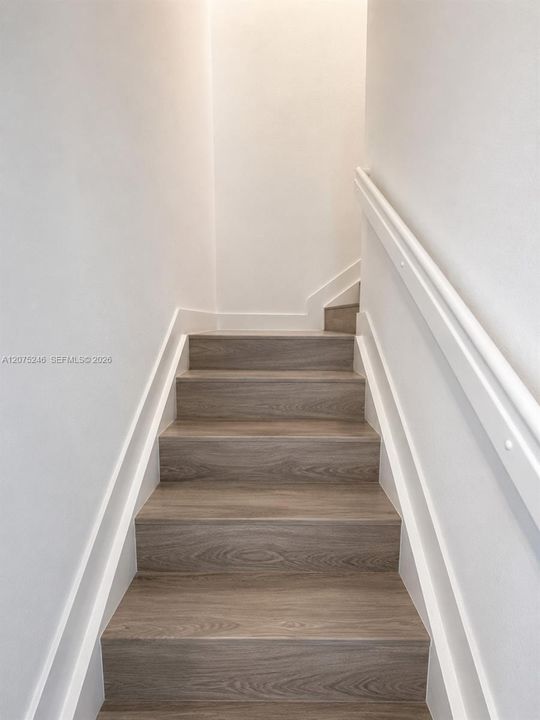 updated staircase with wood-look flooring
